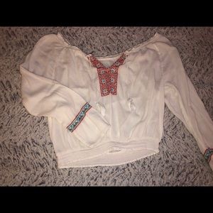 White flowy blouse with blue and red details